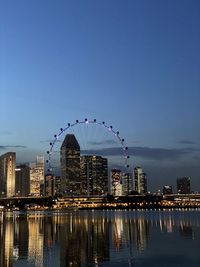 Illuminated buildings in city at waterfront