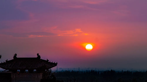Silhouette building against sky during sunset
