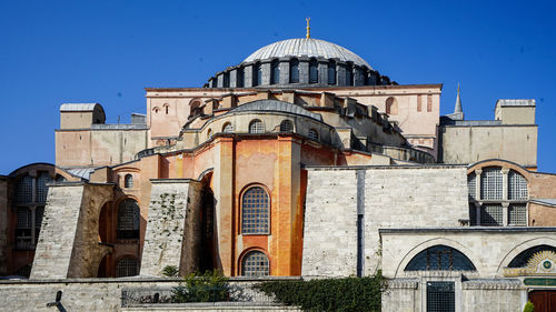 Low angle view of building against clear blue sky