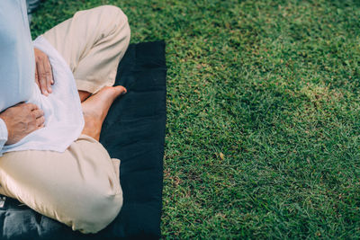 Male therapist performing reiki therapy self treatment holding hands over his stomach