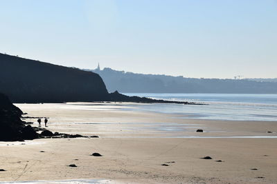 Scenic view of beach against clear sky