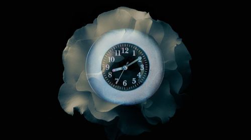 Close-up of clock against black background