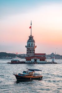 Ship in sea against sky during sunset