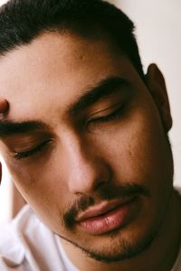 Close-up portrait of young man looking away