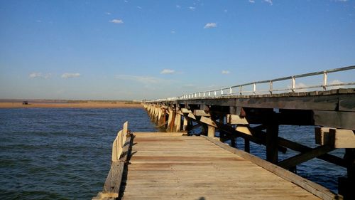 Pier over sea against sky