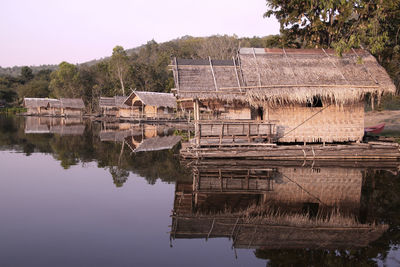 Built structure by lake against sky