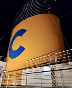 Low angle view of illuminated building against sky at night