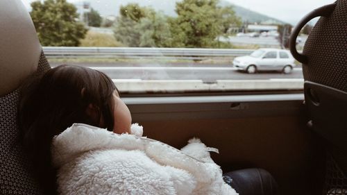 Cropped image of woman sitting in car