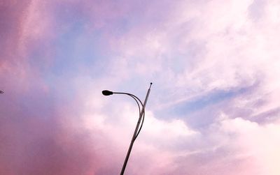 Low angle view of street light against cloudy sky