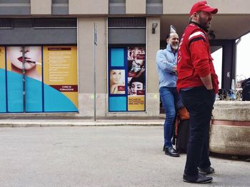 Full length of men standing in city