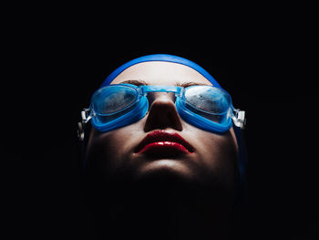 Close up of female swimmer against black background