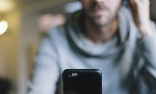 Midsection of man using mobile phone outdoors