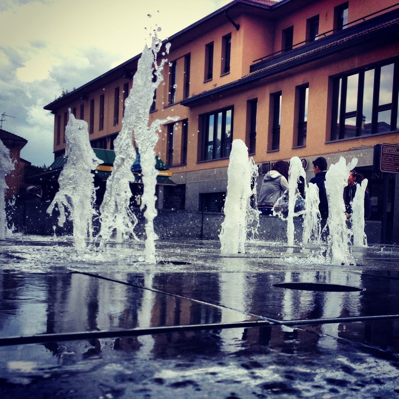 water, fountain, building exterior, architecture, built structure, splashing, reflection, motion, spraying, waterfront, art and craft, art, creativity, statue, sculpture, day, outdoors, building
