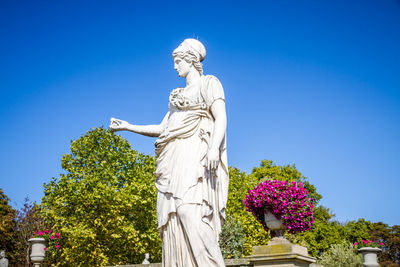 Low angle view of statue against blue sky