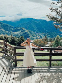 Rear view of woman standing against mountain