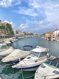 Sailboats moored at harbor