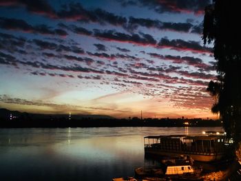 Scenic view of river against sky at sunset