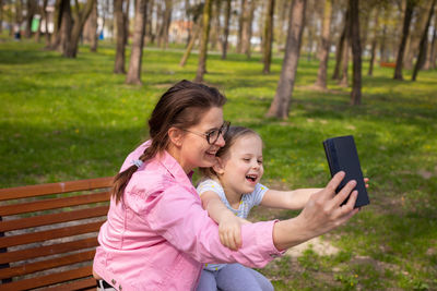 A crazy selfie taken with a smartphone on a bench in a city park.