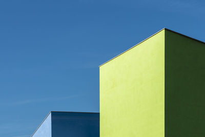Low angle view of building against clear blue sky