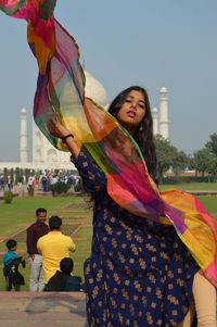 Young woman standing against the sky