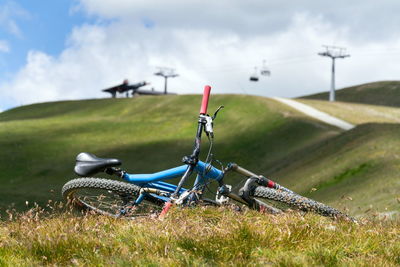 Bicycle on field against sky