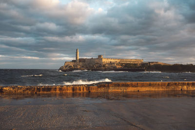 Scenic view of sea against cloudy sky