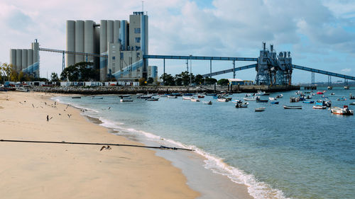 Scenic view of beach against cloudy sky