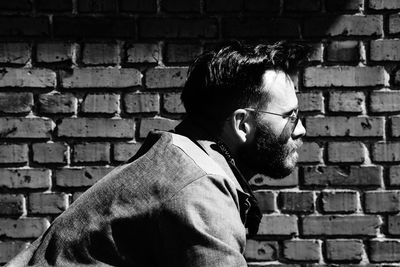 Close-up of man standing against wall