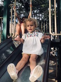 Cute siblings sitting on slide