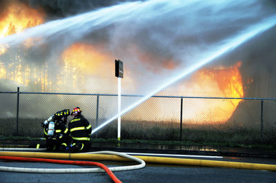 Firefighter extinguishing burning trees