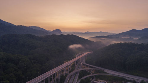 High angle view of bridge over mountains against sky