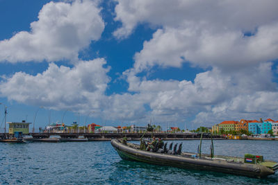 Pier over sea against sky in city