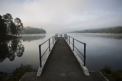 Pier over lake against sky