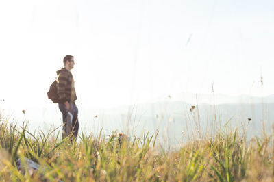 Man standing on field against sky