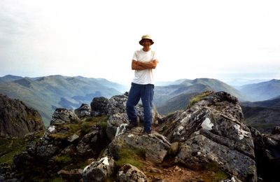 Portrait of man standing on mountains against sky