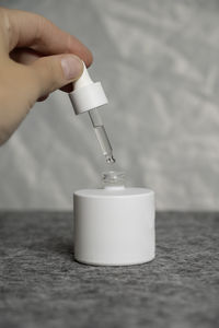 Close-up of hand holding dentures on table