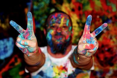 Close-up of hand painting peace sign