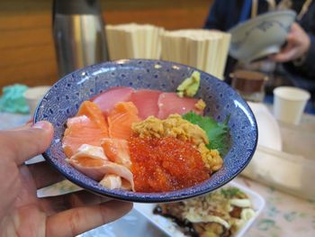 Close-up of man holding food in plate