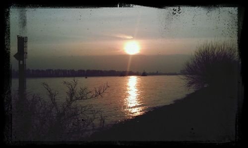 Scenic view of lake at sunset