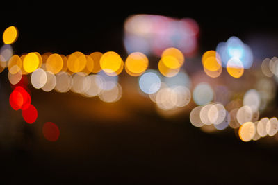 Defocused image of illuminated christmas lights at night
