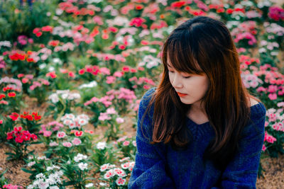 Beautiful woman with red flowers