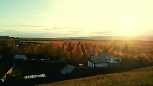 Scenic view of field against sky at sunset