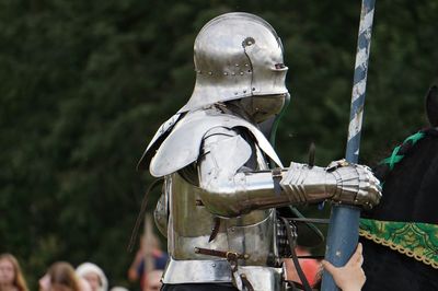 Cropped child holding armor suit