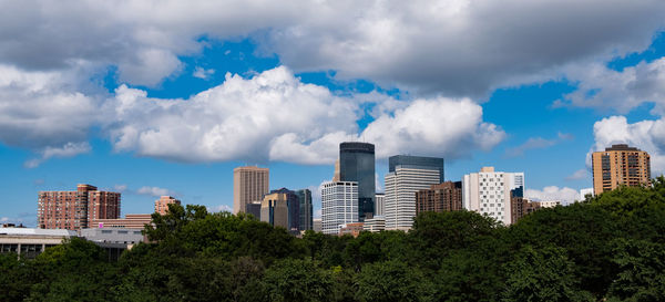 Panoramic view of buildings in city against sky