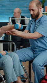 Portrait of man playing with dog