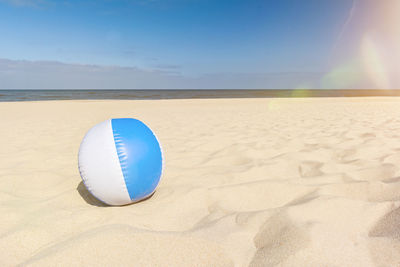 Scenic view of beach against blue sky