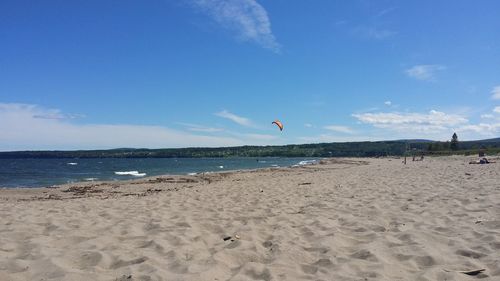 Scenic view of beach against blue sky
