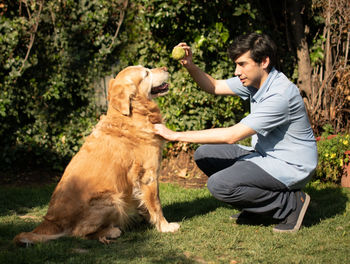 Man playing with dog at park