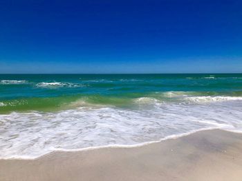 Scenic view of sea against clear blue sky