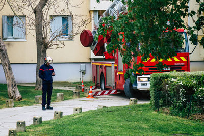 Full length of man standing in yard against building